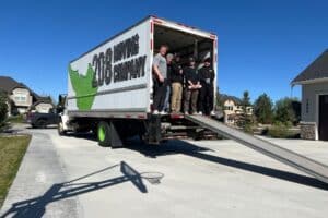 A moving team stands at the back of a moving truck in Boise, Idaho, demonstrating a professional moving service.