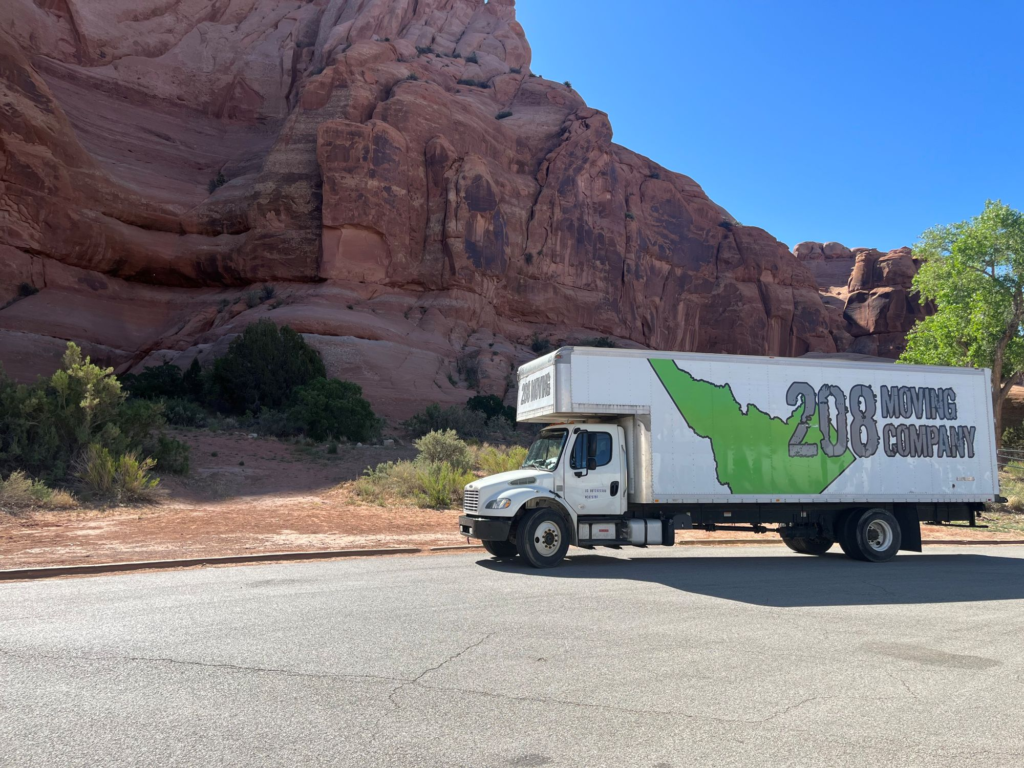 208 Moving long-distance truck parked near red rock landscape during interstate move