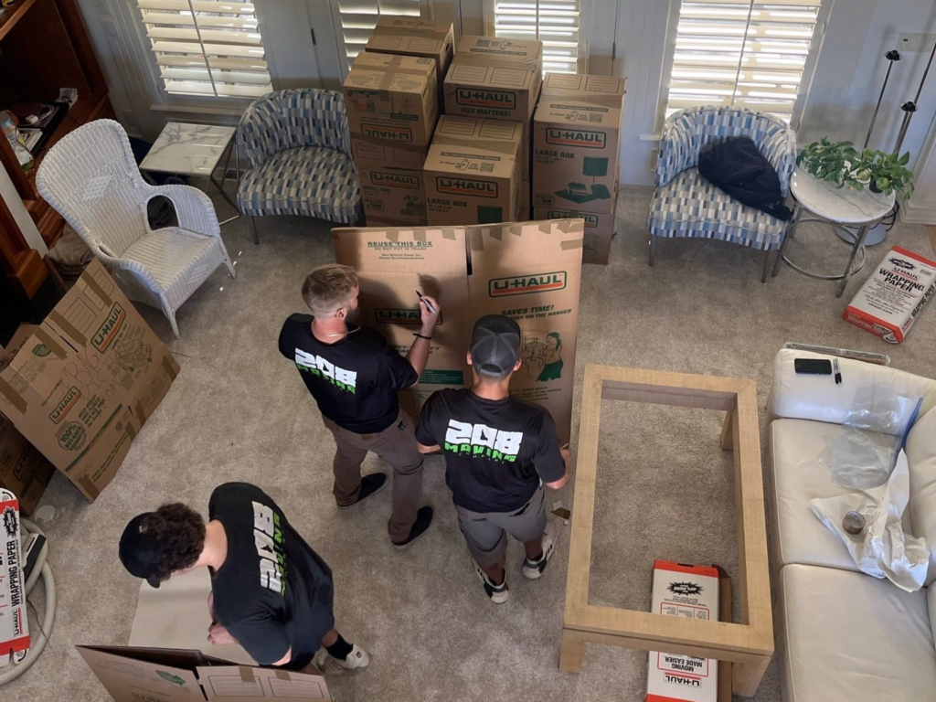 208 Moving professional movers packing boxes inside a residential home in Boise, Idaho