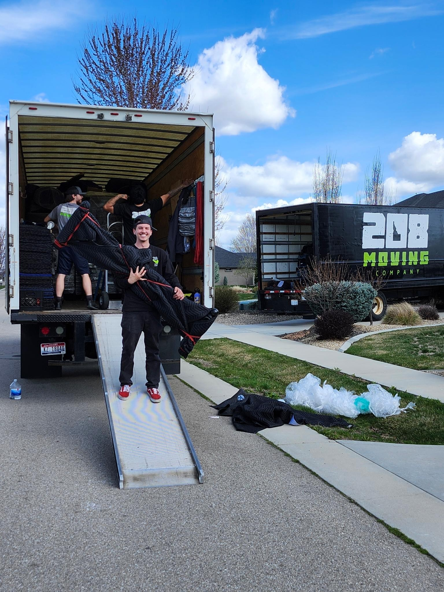Boise residential movers from 208 Moving unloading furniture from a moving truck in a neighborhood driveway