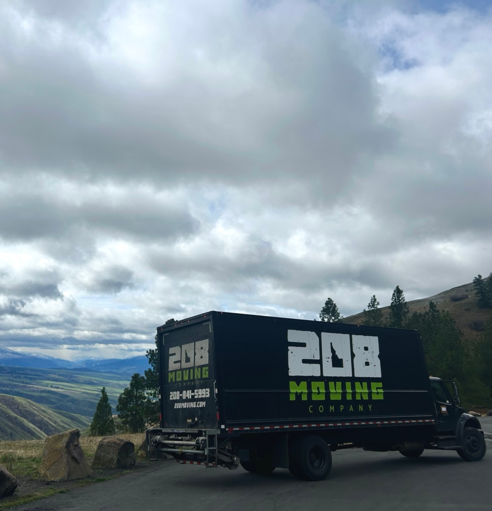 208 Moving Company truck parked on a mountain road overlooking the Idaho landscape